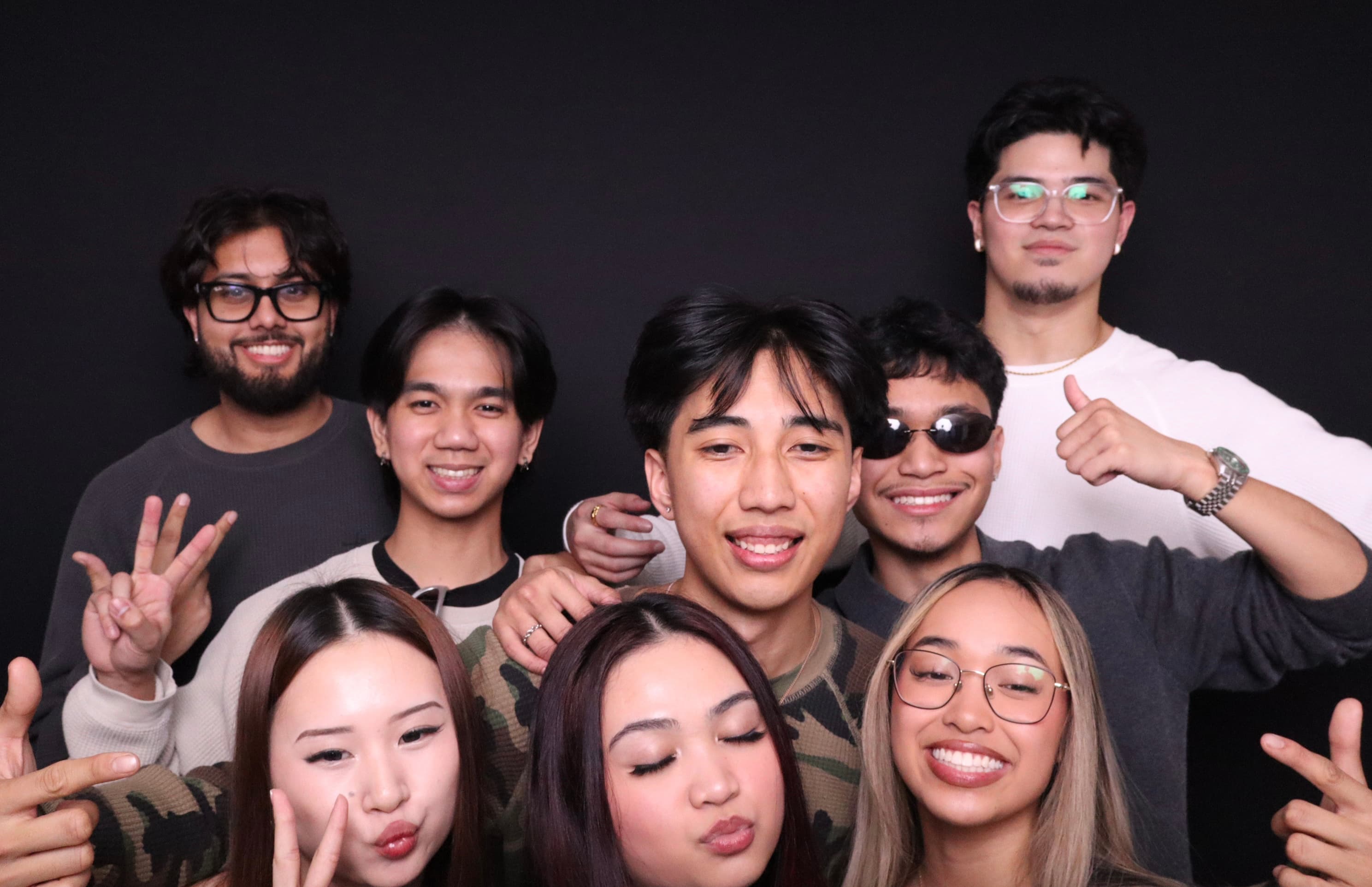 Mixed group of friends smiling at birthday photo booth Vancouver